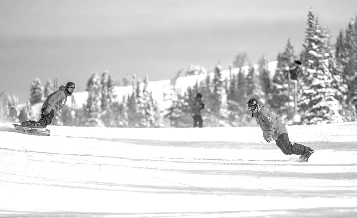 CASI snowboard instructors riding during an on-snow lesson